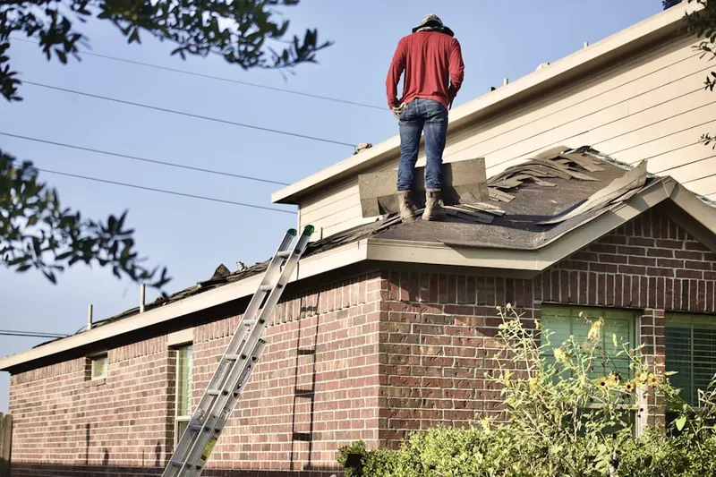 Professional roofer working on a residential roof in River Ridge Country Club
